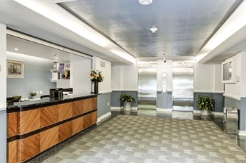 lobby with elevators and patterned carpet at Majestic Apartments in Washington, DC
